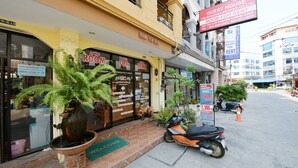 Un hotel con un cartel que dice 'Habitación en alquiler', un cartel que dice 'Casa de huéspedes' y un cartel que anuncia 'Tarifas especiales'.