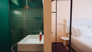 A bathroom with a bathtub, a shower, and a toilet.