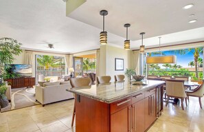 Relax in a spacious room with a large island, seating area, and ocean views.