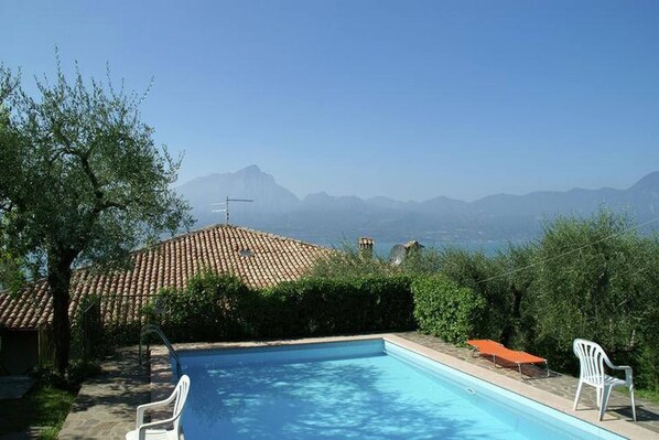 A swimming pool with a view of mountains in the background.