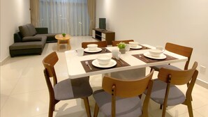 A modern living room with a dining area. - AZ Hotel & Serviced Apartments (Labuan)