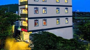 A multi-story hotel with a flat roof and a sign indicating it is a "HOTEL". - Dinh Sa Ly Son Hotel (Ly Son)