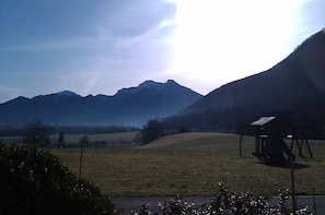 A rural landscape with a playground and a mountain range in the background. - Hoderhof (Grassau)