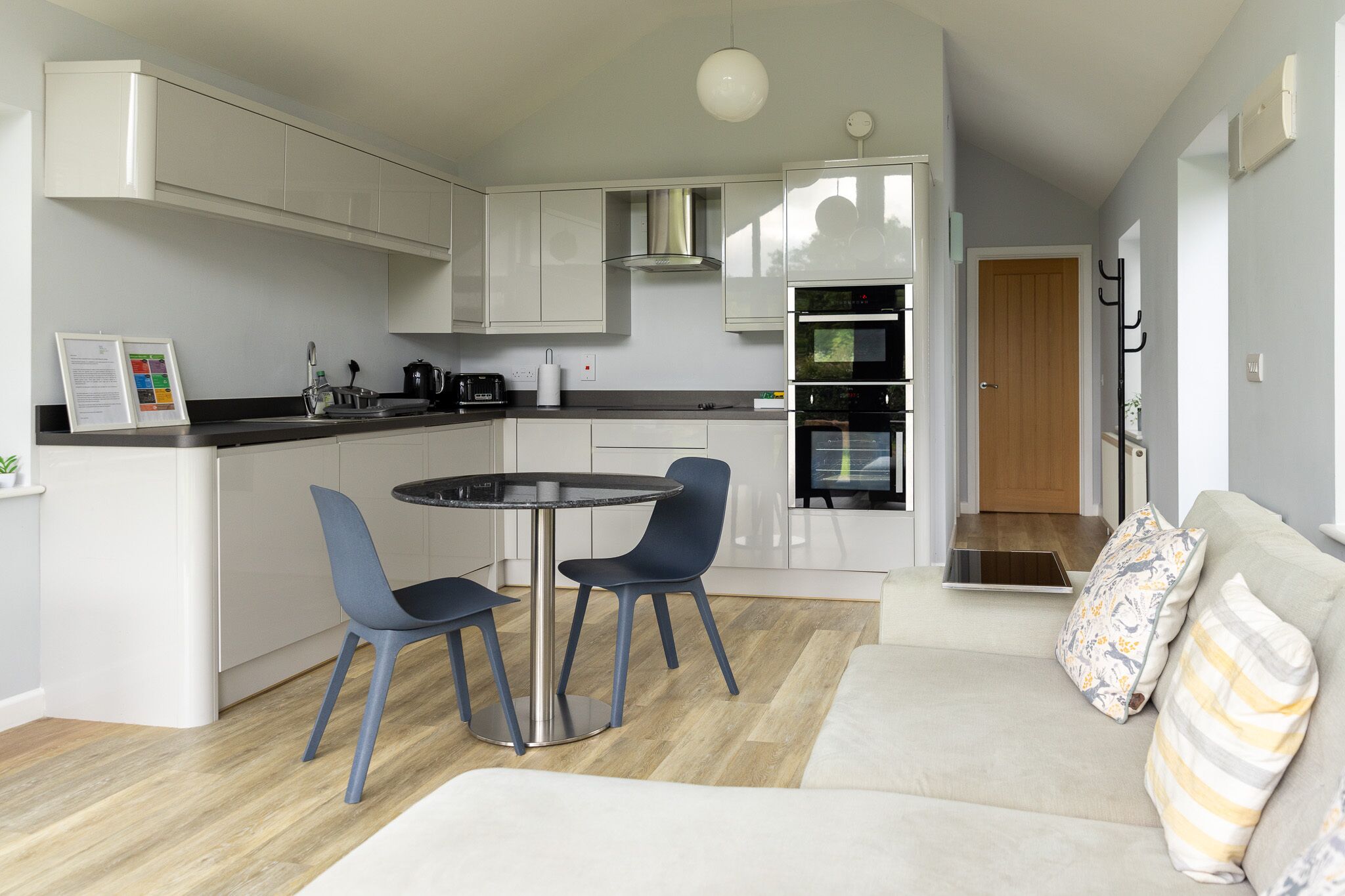 A compact living space with a kitchenette, dining area, and seating area.