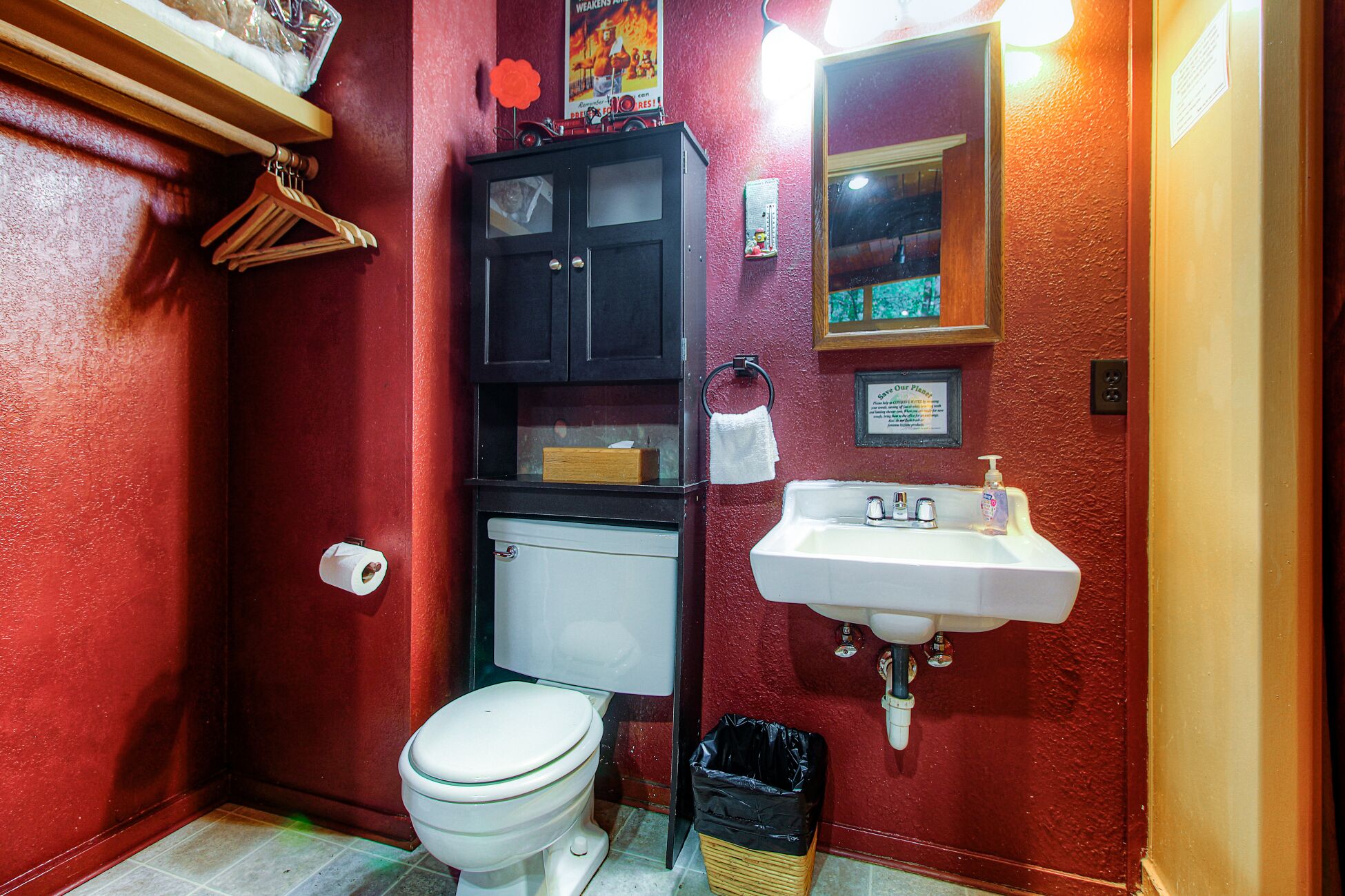 A compact bathroom with a toilet, sink, and a small cabinet.