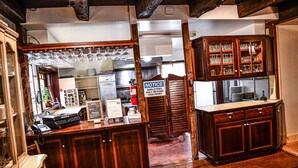 A bar area with wooden cabinets, a counter, and a notice sign.