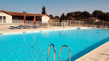 A heated pool, sun loungers