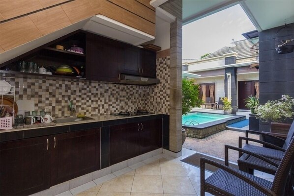 Enjoy a meal in the kitchen with a patio view of the pool and surrounding buildings.