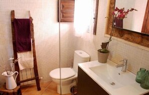 Chuveiro, toalhas de banho, sabonete, papel higiênico