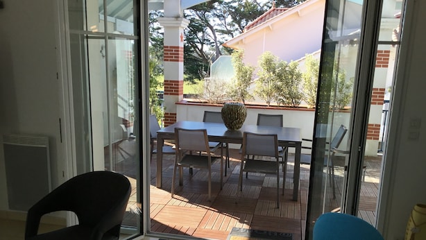 A room with a sliding glass door leading to an outdoor patio area.