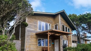A two-story wooden house with a covered porch and a visible door number. - Nye Beach, Close to everything, Ocean View! (Newport)