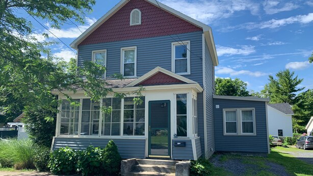 A two-story house with a red roof, large windows, and a front porch. - Summer And Track Season Rental (Saratoga Springs)