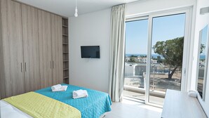 A bedroom with a bed, a wardrobe, a TV, and a view of the outside. - Luxury 5 Bedroom Villa with Private Pool, Protaras Villa 1250 (Protaras)