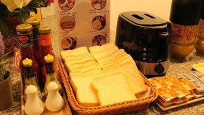 A kitchen counter with bread, salt and pepper shakers, a toaster, and condiments. - Avalon residence2 (Savannakhet)