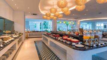 A modern breakfast bar with a variety of food options and a decorative ceiling.