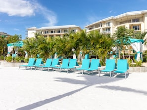 Relax on the beach with access to the ocean from our hotel's lounge chairs.