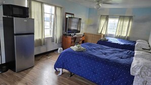 A bedroom with two beds, a television, a refrigerator, and a ceiling fan. - Mountaineer Motel - Standard room (Mt Storm)