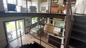 A multi-level interior with a staircase, a dining area, and a kitchen.