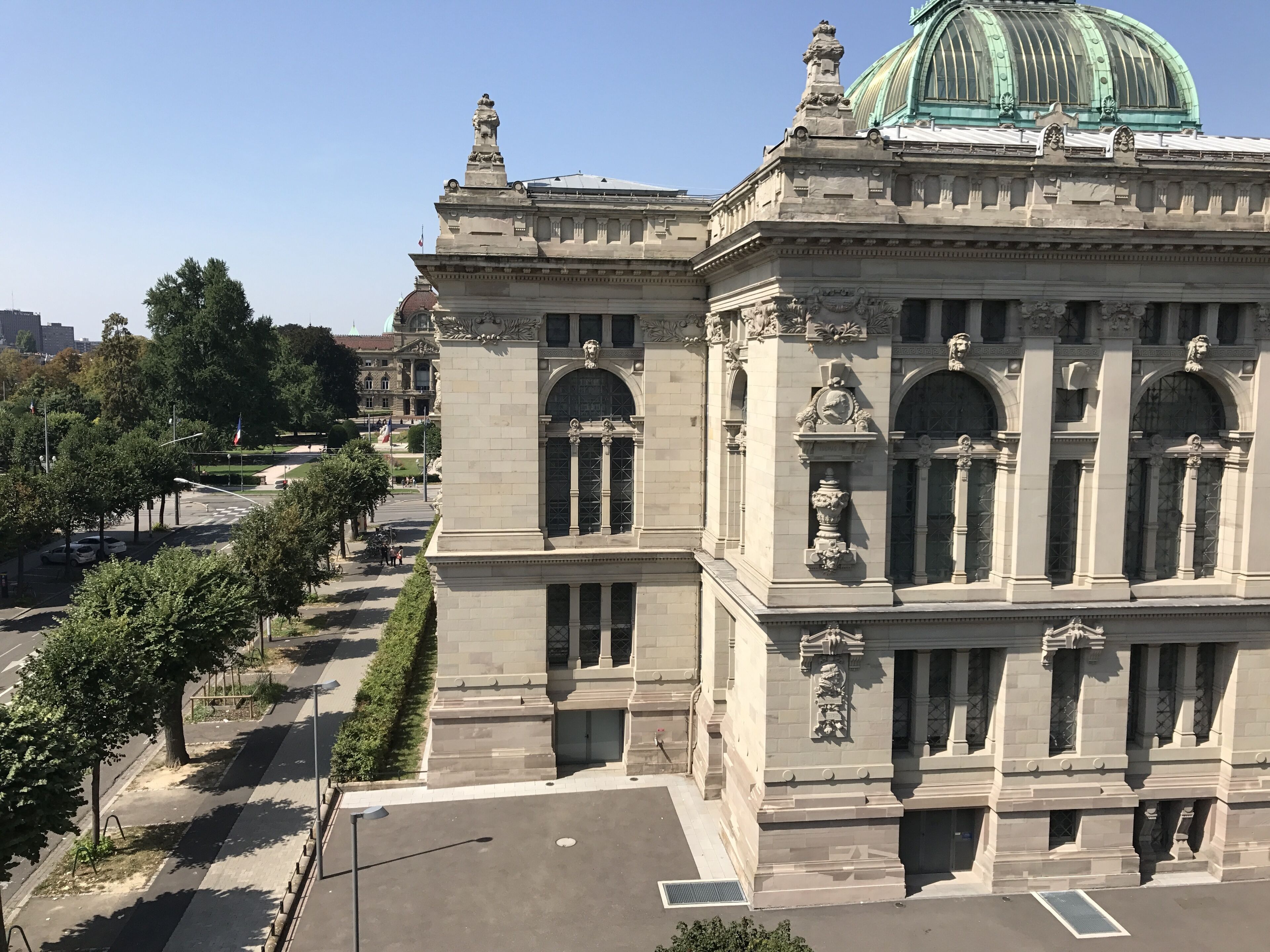 A large building with classical architecture, featuring columns and a dome.