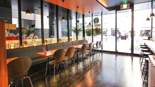 A modern cafe with wooden flooring, metal chairs, and pendant lighting. - Hotel Livemax Osaka Yodoyabashi (Osaka)