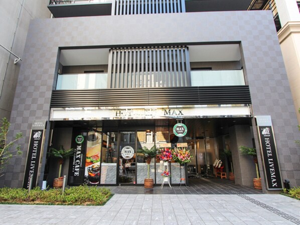A hotel entrance with a sign reading "HOTEL MAX".