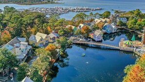 A marina with boats docked, surrounded by trees and buildings. - 2BR Beach Villa w/6-Seat GOLF CART! Near Pool, Tram, Beach. Screened Balcony (Miramar Beach)