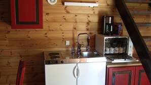 A compact kitchen with a stove, sink, and dishwasher. - Idyllic place for a relaxing holiday (Årjäng)
