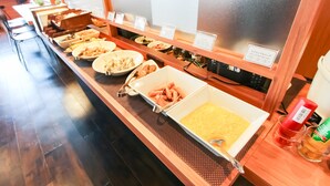 A buffet with various food items and a condiment station. - HOTEL LiVEMAX PREMIUM Himejieki-Minami (Himeji)