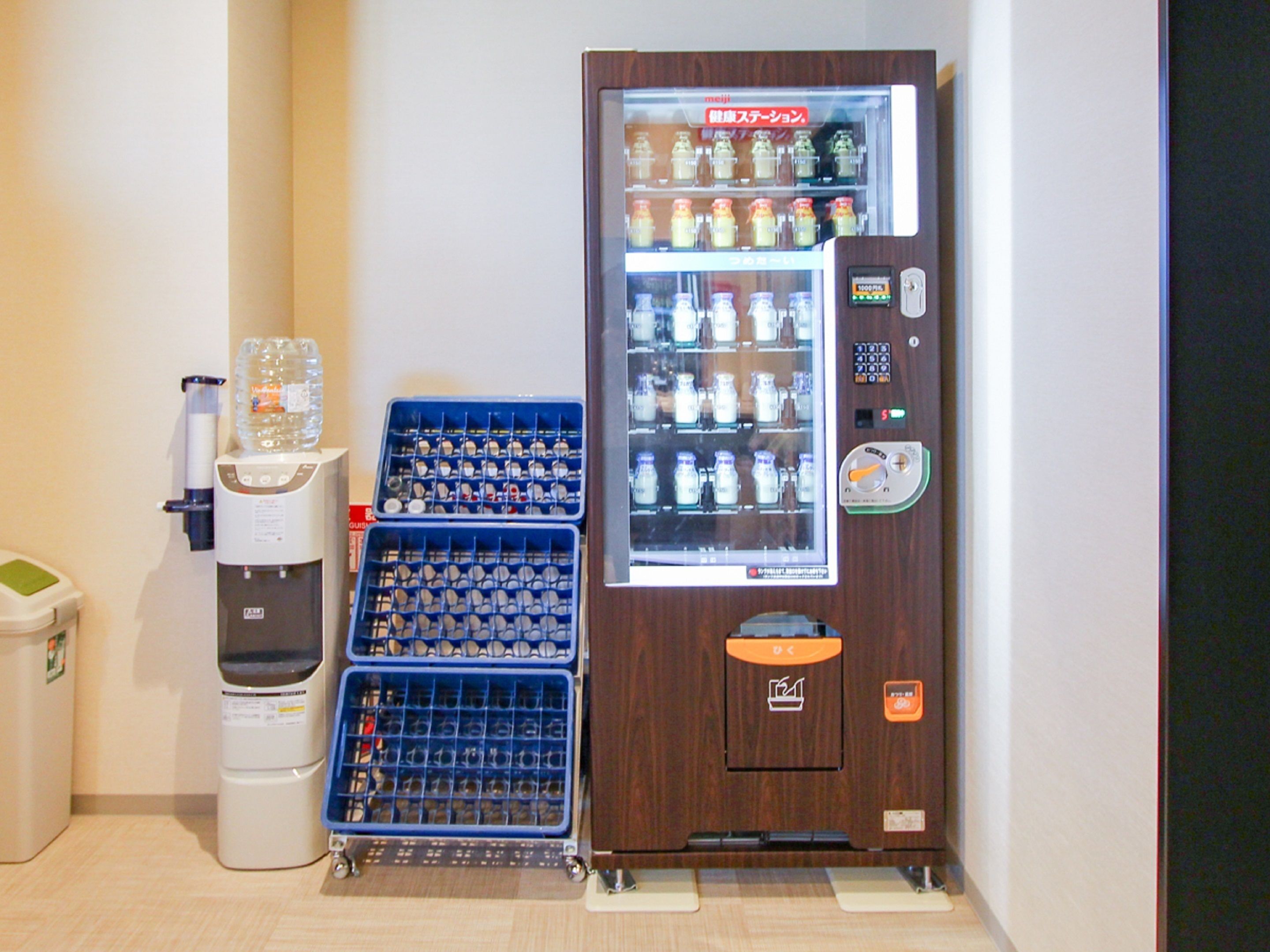 A vending machine with bottles and a water dispenser.