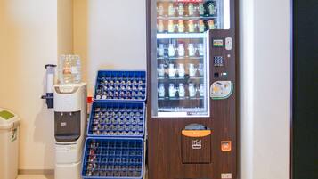 A vending machine with bottles and a water dispenser.