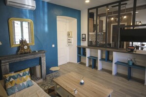 A living room with a fireplace, a television, and a dining area. - Nice apartment in the city center, quiet. Elevator. (Corte)