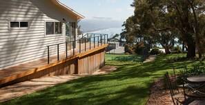 A residential property with a wooden deck, a tennis court, and a view of the ocean. - The White House Ocean Views Tennis Court in Lorne (Lorne)