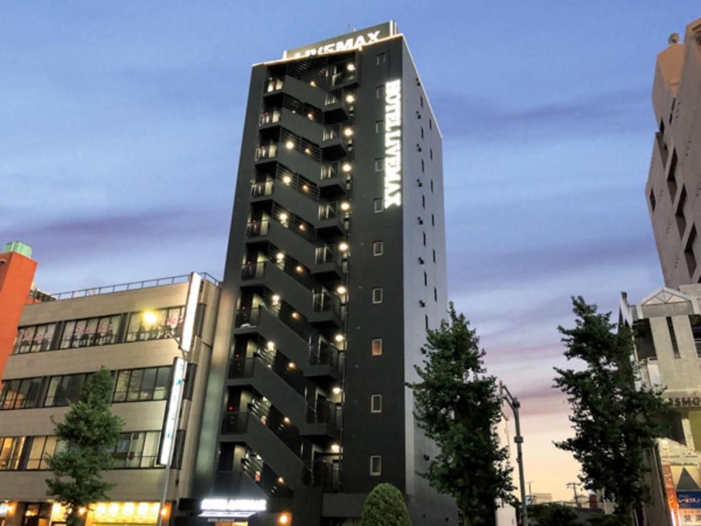 A multi-story building with balconies and a sign that reads 'CINEMA MAX'.