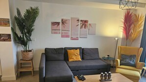 A modern living room with a grey sectional sofa, a yellow armchair, a wooden coffee table, and a potted plant. - The Buddha House Torrox Costa (Torrox Costa)