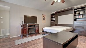 A bedroom with a bed, a TV, a bookshelf, and a desk. - See the Valley of the Sun, Arizona State University and Tempe just a short walk. (Tempe)