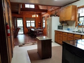 Kitchen area with refrigerator, microwave, and sink, offering a convenient space for meal preparation.