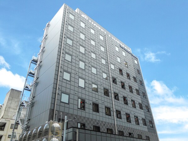 A modern hotel building with a grid of windows and a visible sign reading "HOTEL LEVY". - HOTEL LiVEMAX Numazu Ekimae (Numazu)