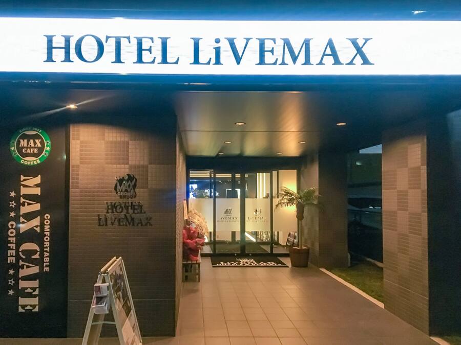 The entrance to HOTEL LIVEMAX with a MAX Cafe sign on the left.