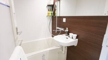 A bathroom with a bathtub, a sink, and a toilet.