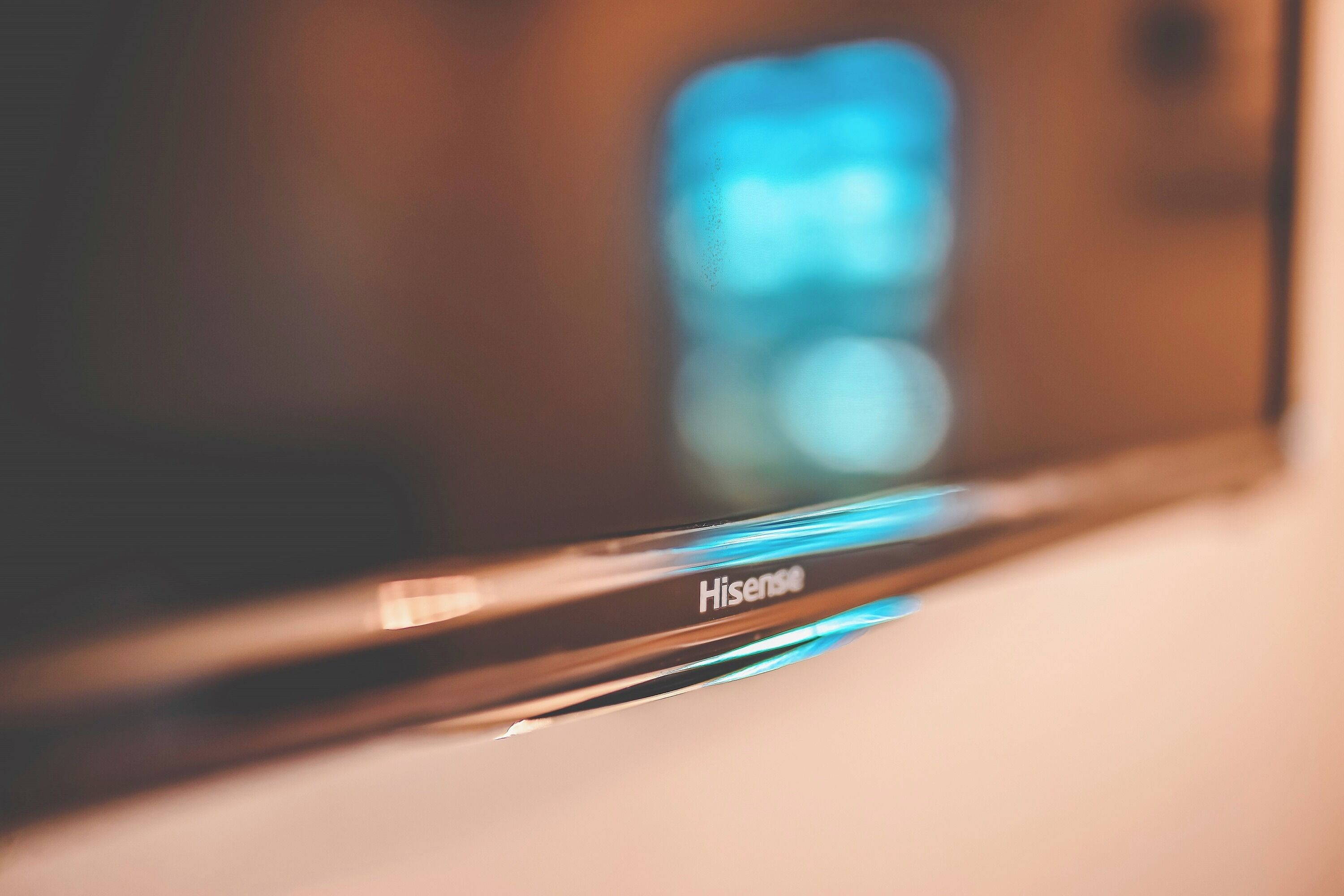 A close-up of a Hisense television with a blurred background.