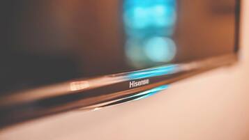 A close-up of a Hisense television with a blurred background.