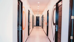 A hallway with doors on both sides, each with a circular design.