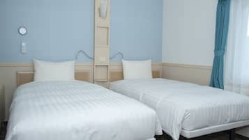 A hotel room with two beds, a bedside table, a wall clock, and a control panel on the wall.