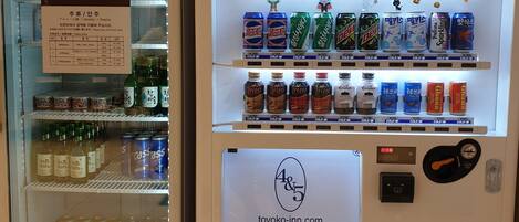 A vending machine with a variety of beverages and snacks, including Coca-Cola, Sprite, and Mountain Dew.