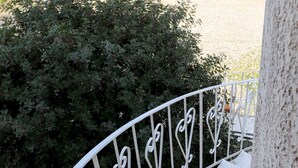 A white metal staircase with a textured metal floor leading up to a building. - Tsolis Village (Aigialeia)
