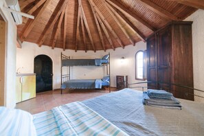 A room with a bunk bed, a desk, a window, and a door. - Tsolis Village (Aigialeia)