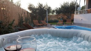 A hot tub with two glasses of red wine on a tray. - Luxury Villa Petra near Split (Kastela)