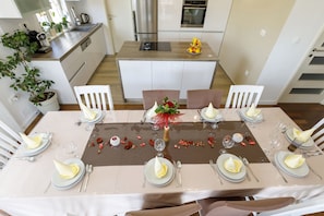 Enjoy a meal in the stylish dining area with a stove and elegant table setting.
