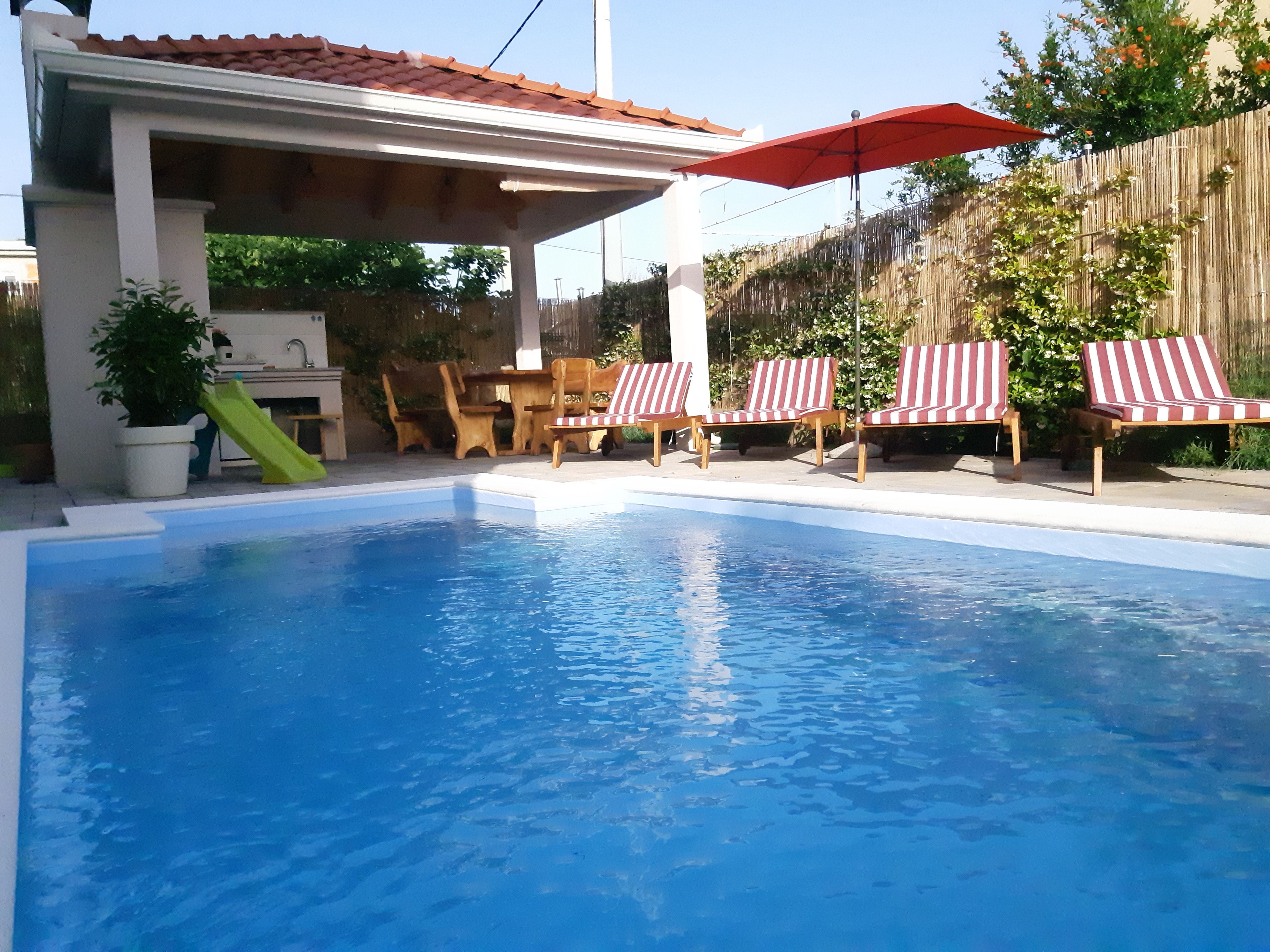 Seasonal outdoor pool, open 6:00 AM to midnight, pool umbrellas