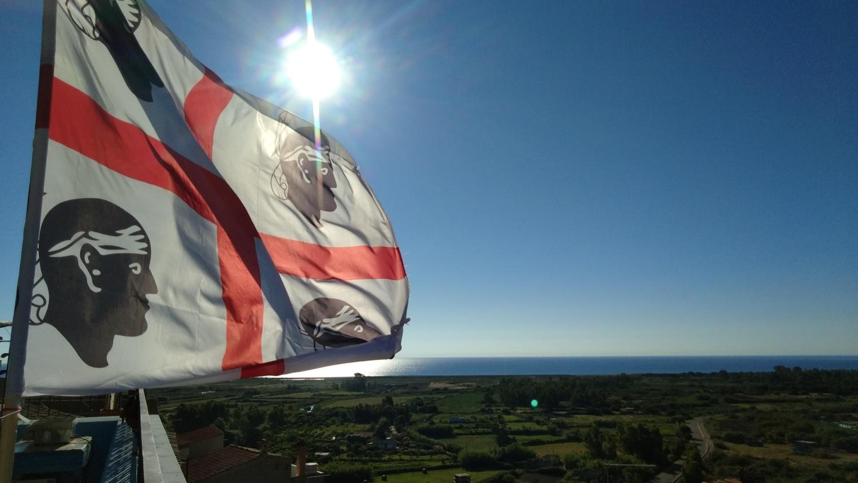 Una bandera con el perfil de una mujer y un hombre, y una cruz roja.